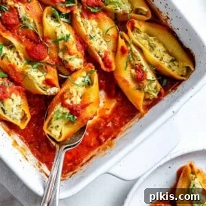 completed Stuffed Shells in a white baking dish against a white background