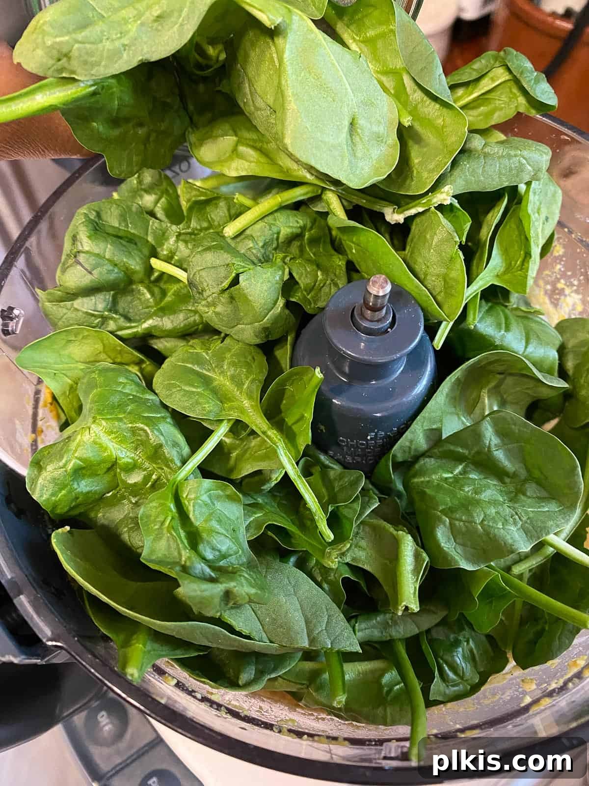 Creamy Vegan Stuffed Shells 8 Fresh spinach being added to the partially blended tofu ricotta mixture in the food processor for the next pulsing step.