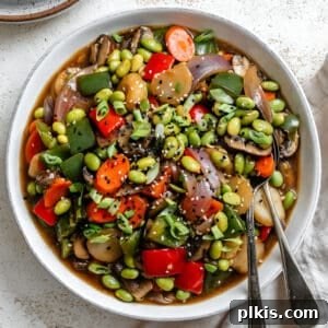 completed Quick Vegetable and Edamame Stir-Fry on a white surface