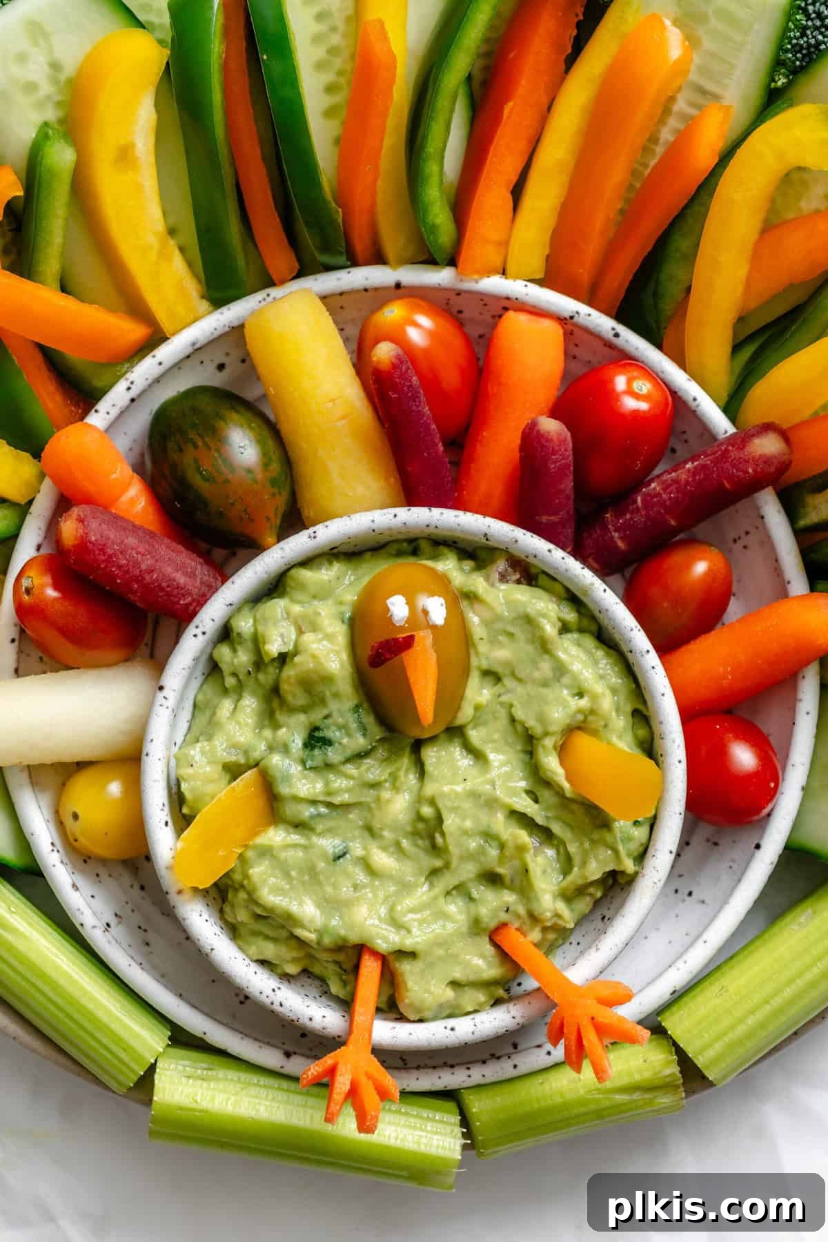 Effortless Holiday Veggie Platter 7 Process shot showing assembling the turkey's facial features onto the dip.