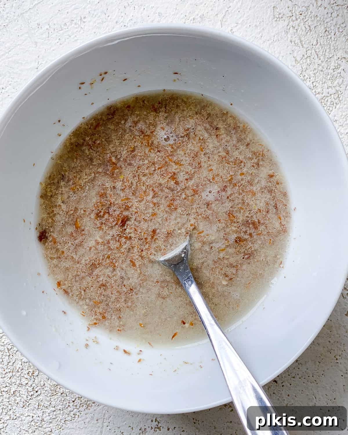 Golden Sweet Potato Latkes 4 Process shot showing flax meal mixed with water in a bowl