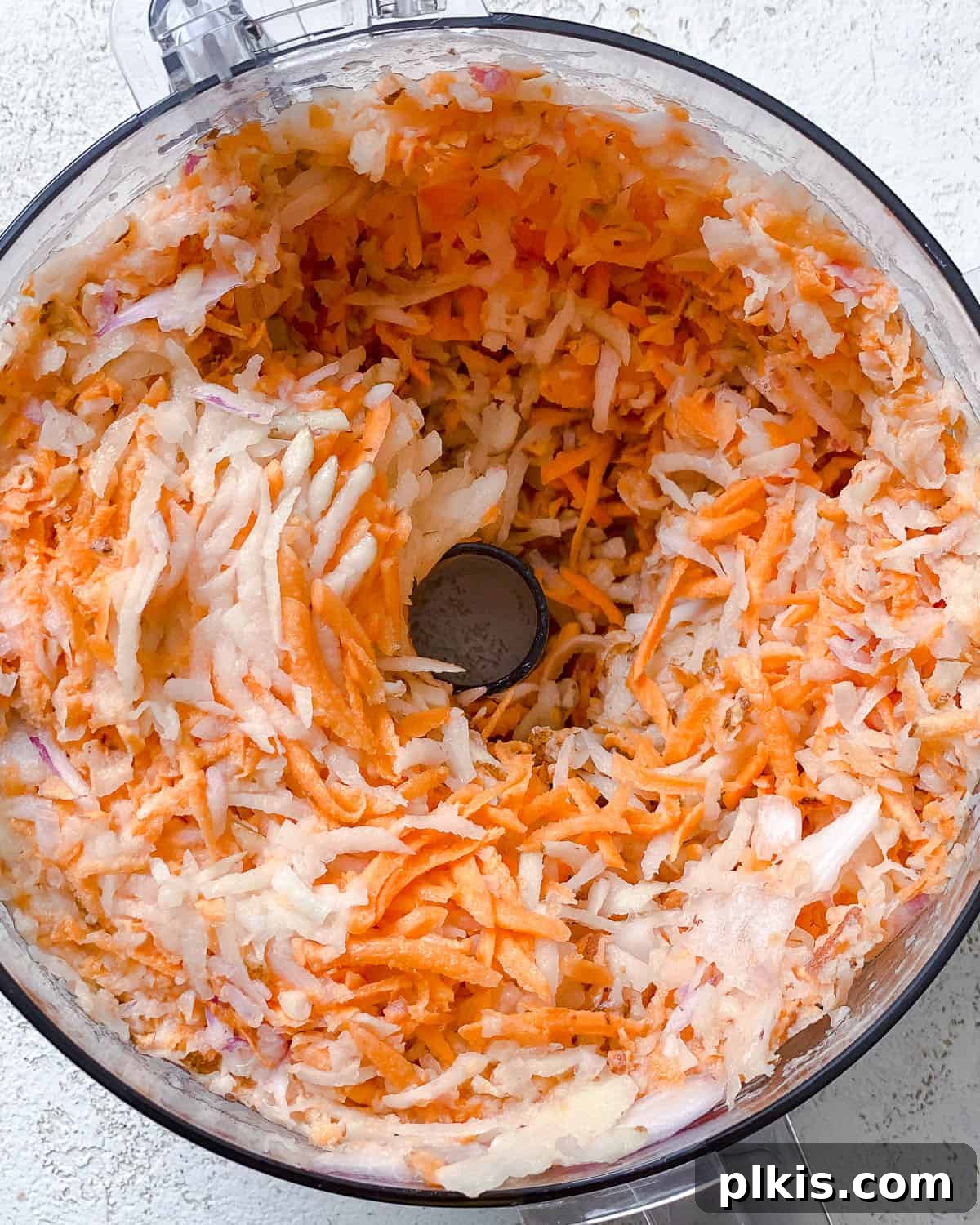 Golden Sweet Potato Latkes 5 Process shot showing ingredients being added to a food processor