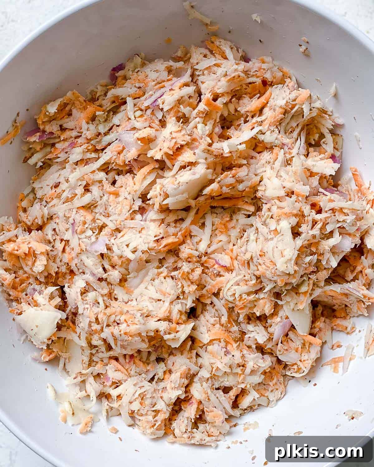 Golden Sweet Potato Latkes 6 Process shot showing mixed ingredients in a large bowl