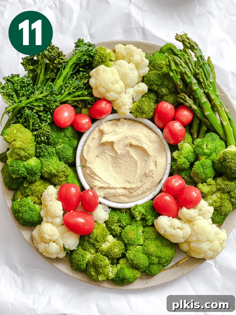 Christmas Tree Veggie Tray 14 Completing the veggie wreath by adding various colorful vegetables like tomatoes and more.