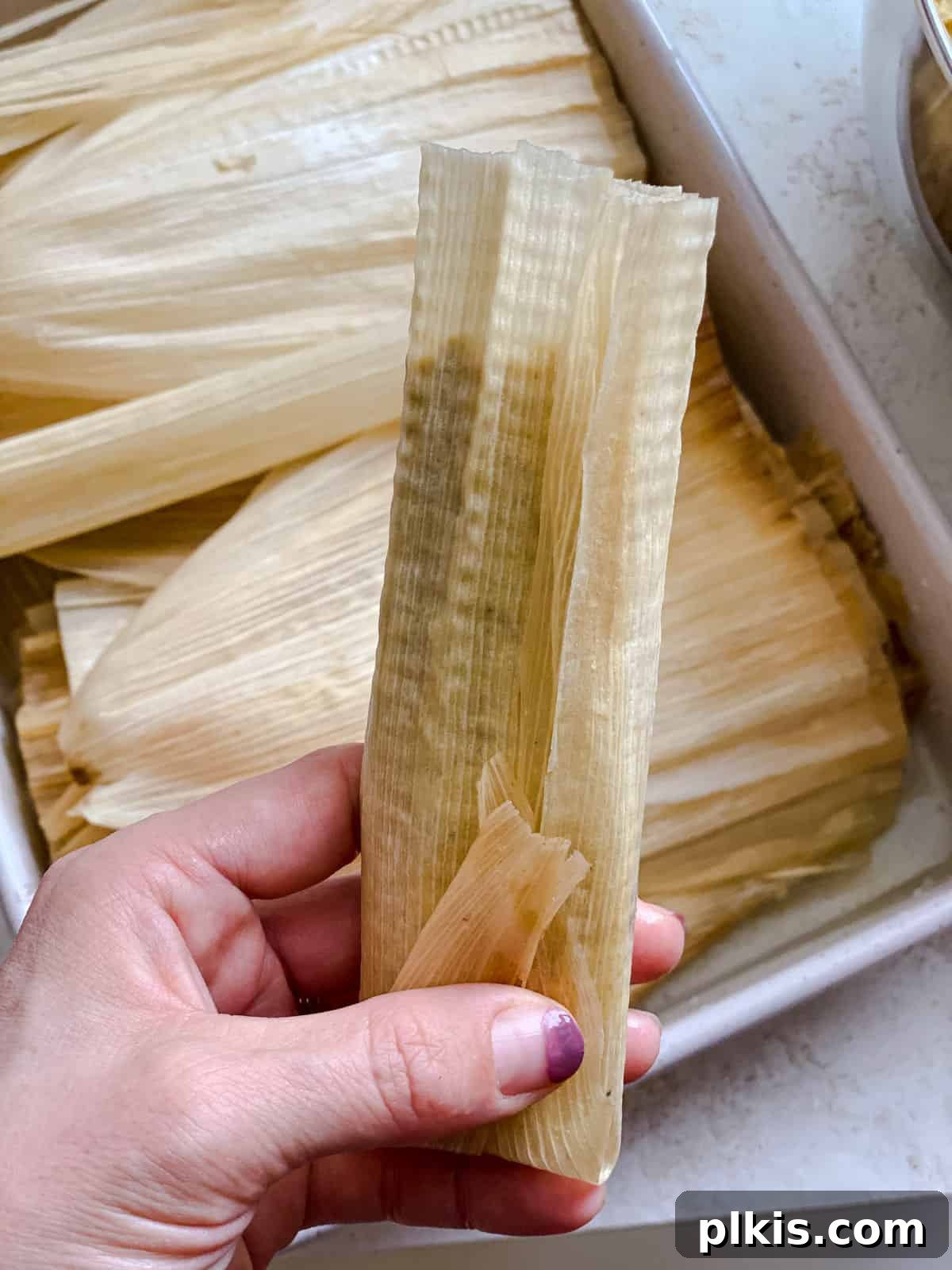 Crafting Perfect Vegan Tamales 13 Process shot of rolling the corn husk to enclose the tamale mixture.
