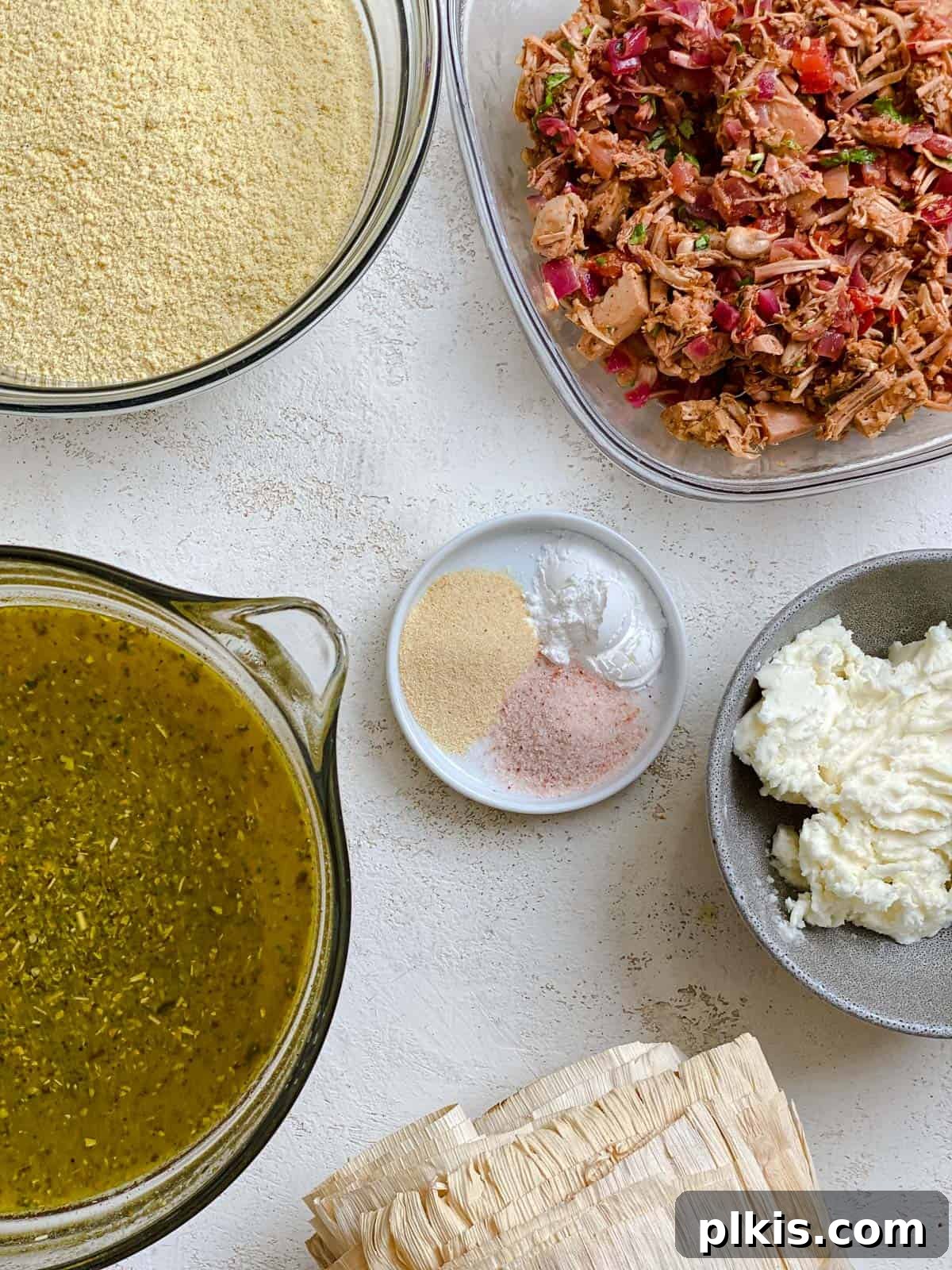 Crafting Perfect Vegan Tamales 3 A collection of measured ingredients for vegan tamales laid out on a white surface.