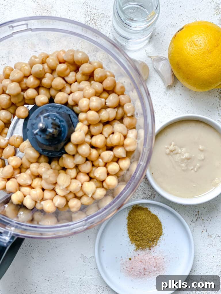 Quick & Creamy Hummus 4 A selection of measured ingredients for easy hummus, including chickpeas, tahini, and lemon, ready for blending.