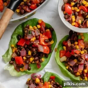 Several completed Vegetarian Lettuce Wraps (Beans & Corn) on a white surface.