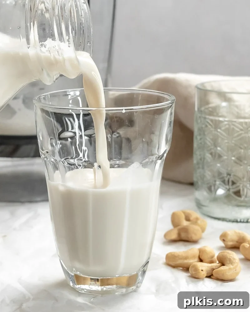 Whip Up Your Own Cashew Milk 2 completed Cashew Milk being poured into a glass, highlighting its smooth, creamy texture