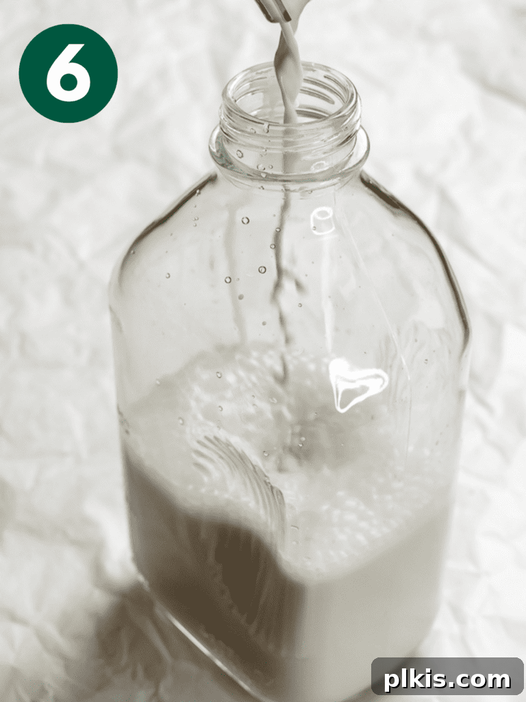 Whip Up Your Own Cashew Milk 9 process shot of pouring finished cashew milk into a jug