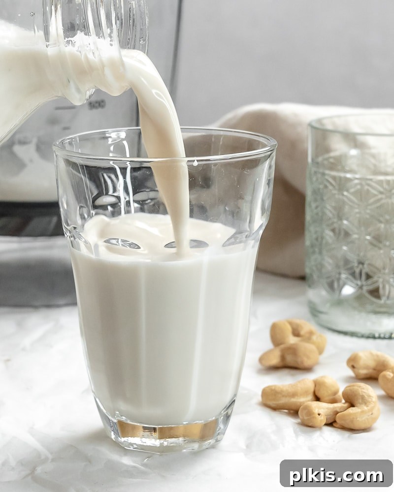 Whip Up Your Own Cashew Milk 10 completed Cashew Milk being poured into a glass, showcasing its smooth texture