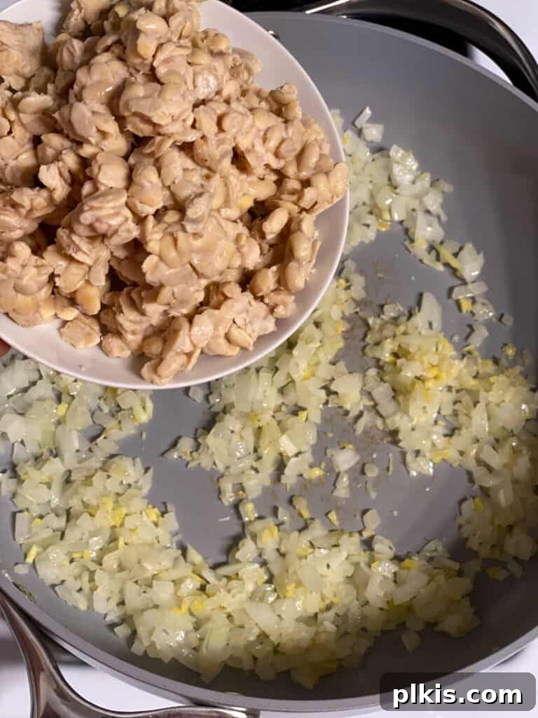 Crispy Tempeh with Zesty Ginger-Soy Glaze 7 Process shot of crumbling tempeh directly into the pan with aromatics.