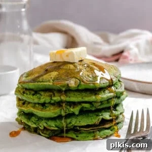 completed stack of Easy Banana Spinach Pancakes against a light surface