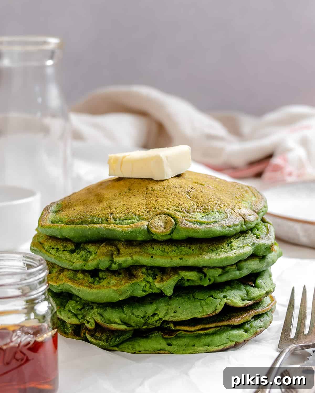 Green Power Banana Pancakes 9 A delicious stack of Banana Spinach Pancakes, perfectly green and fluffy, ready to be enjoyed as a healthy and vibrant breakfast.
