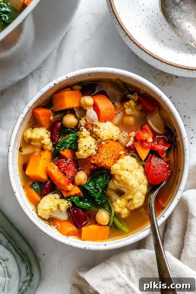 Nourishing Kale and Bean Harvest Soup 2 completed Kale Vegetable Bean Soup on a white surface