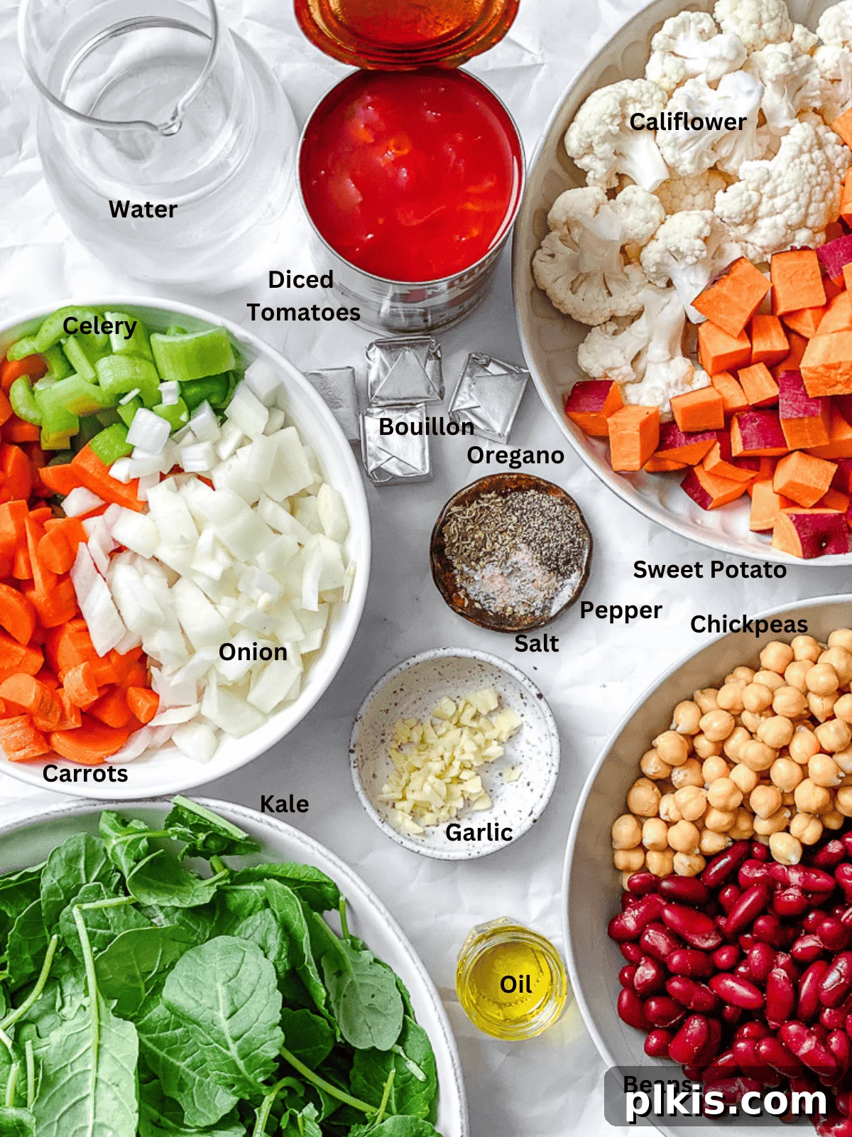Nourishing Kale and Bean Harvest Soup 3 ingredients for Kale Vegetable Bean Soup measured out on a white surface