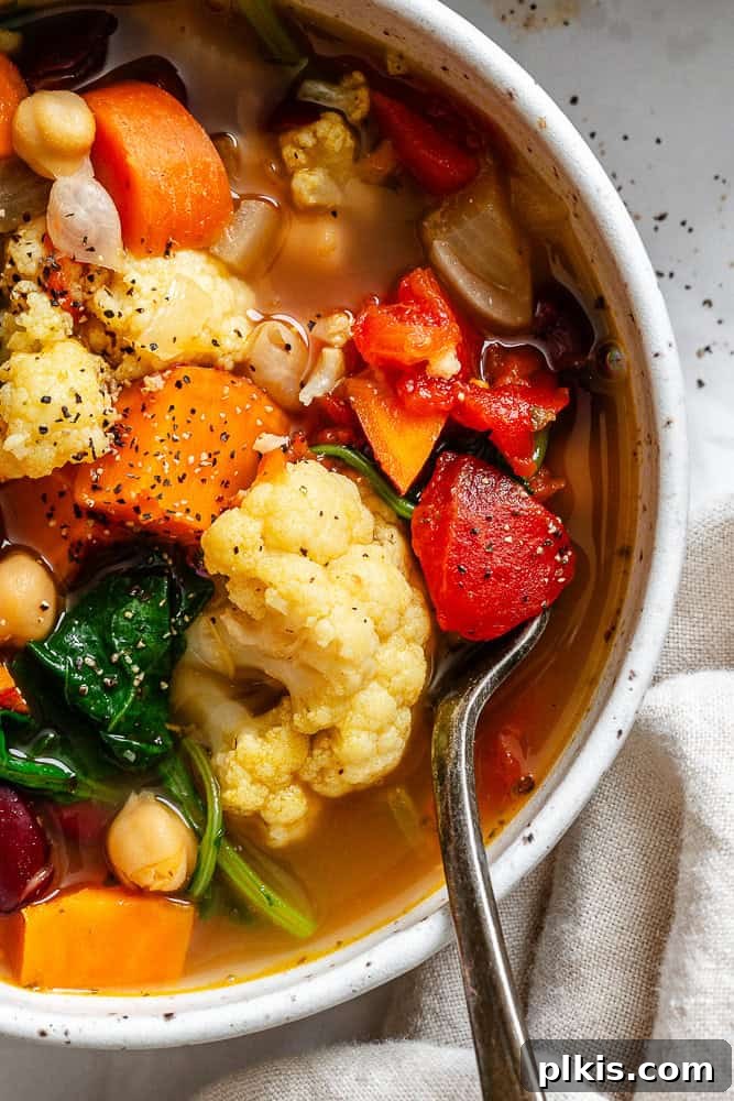 Nourishing Kale and Bean Harvest Soup 7 completed Kale Vegetable Bean Soup on a white surface