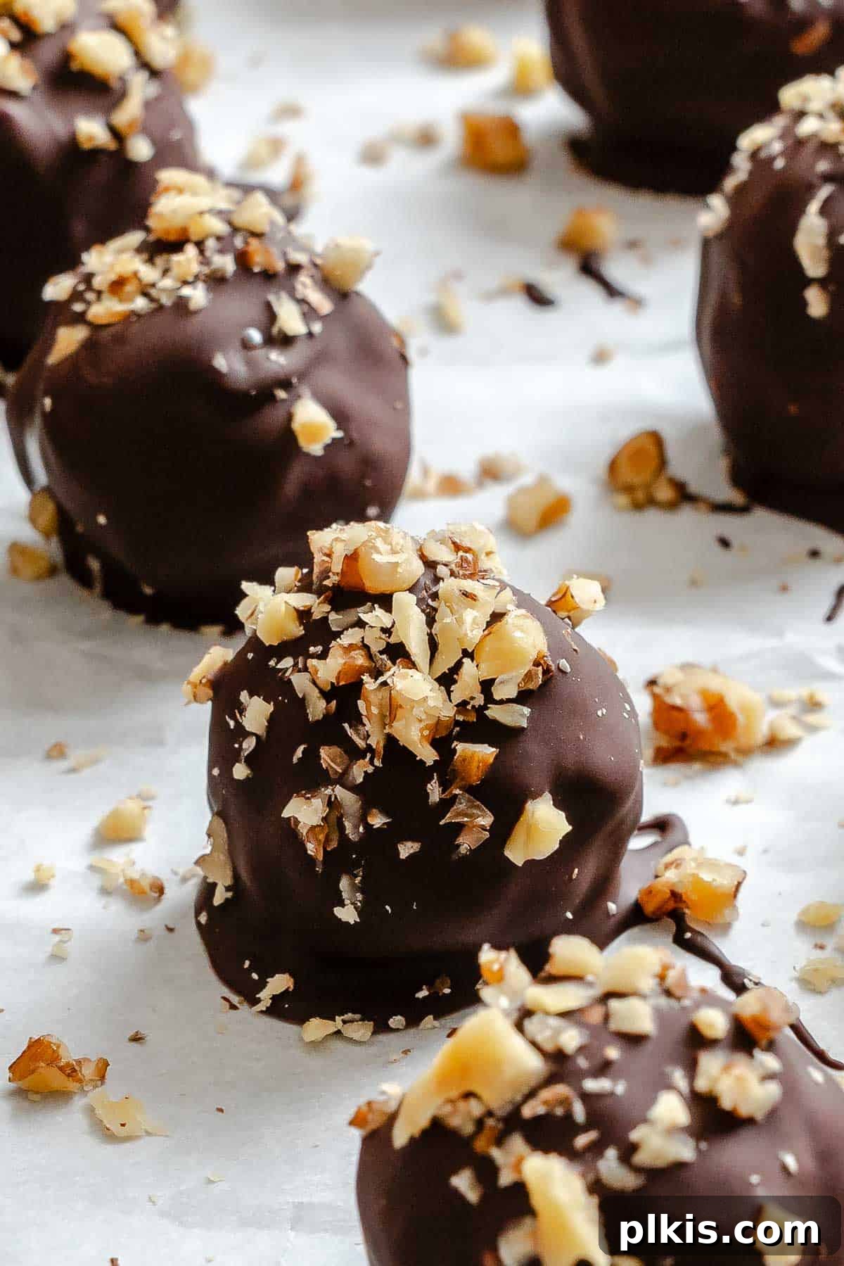 Loaded Chocolate Peanut Butter Truffles 2 Completed Chocolate Covered Peanut Butter Balls (+ Add-Ins) on a baking sheet.