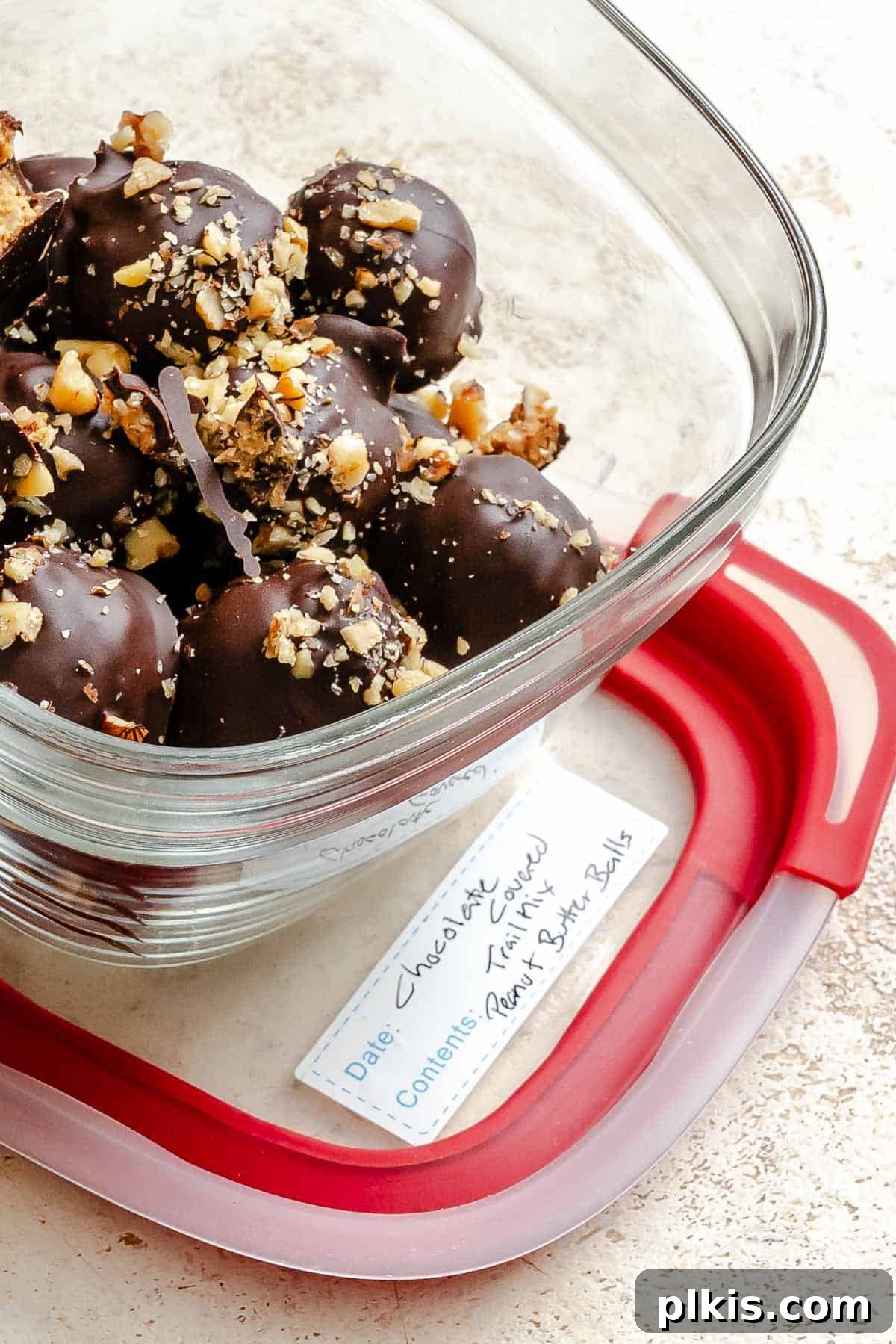 Loaded Chocolate Peanut Butter Truffles 8 Completed Chocolate Covered Peanut Butter Balls (+ Add-Ins) in a storage container.