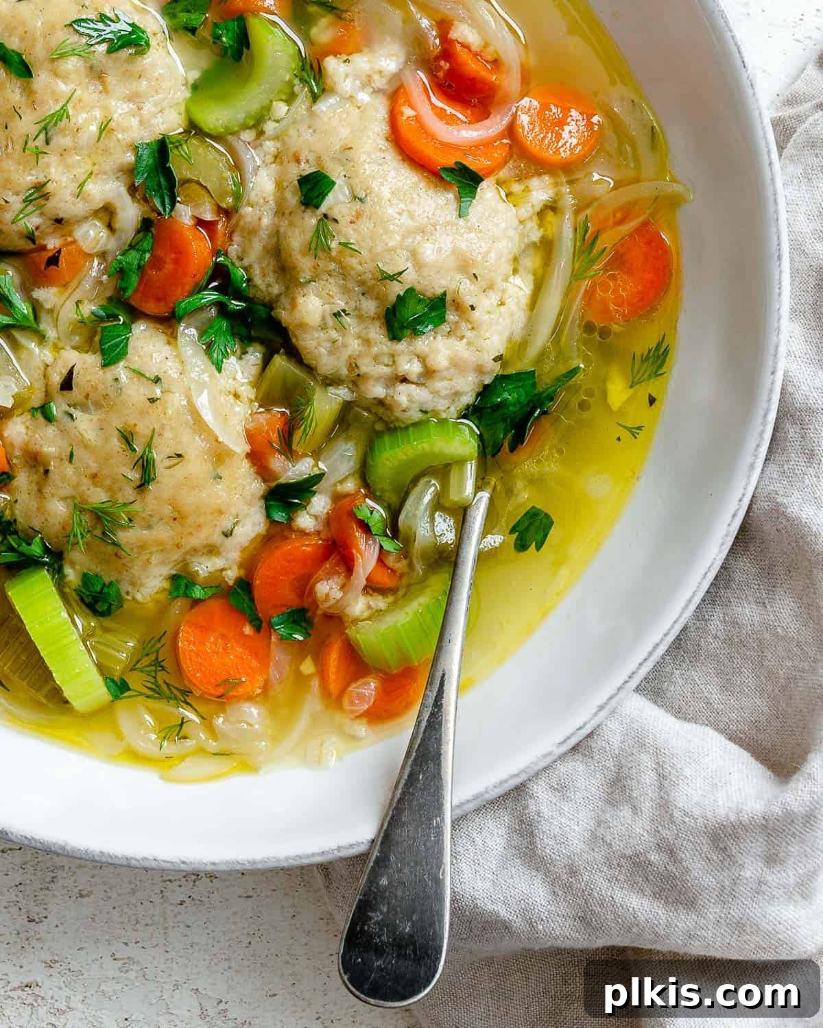 Comforting Vegan Matzo Ball Soup 17 completed Vegan Matzo Ball Soup in a bowl with a spoon
