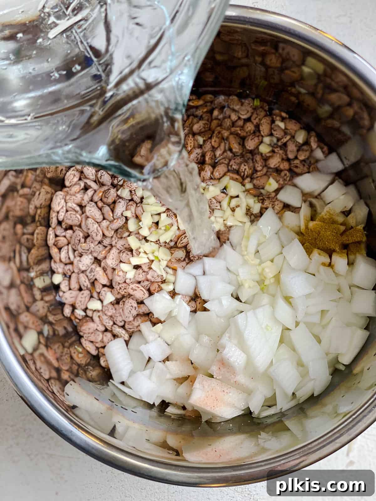 Perfectly Cooked Instant Pot Pinto Beans 7 process shot of pouring water into instant pot