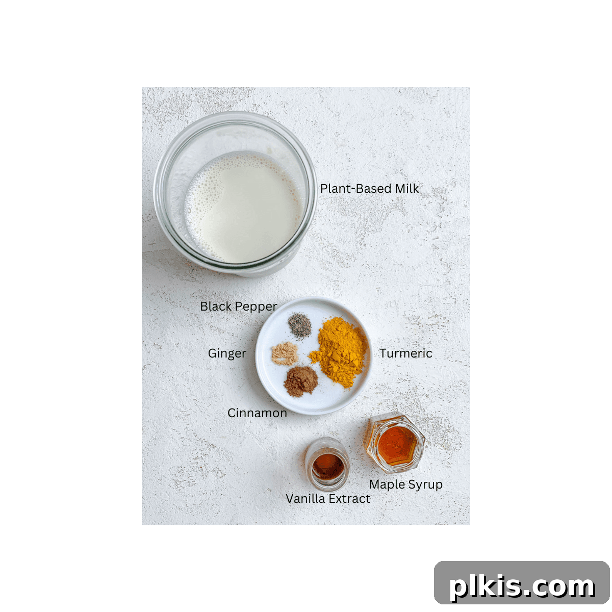 Golden Turmeric Elixir 3 All the essential ingredients for Golden Milk carefully measured and arranged on a clean white surface, ready for preparation.