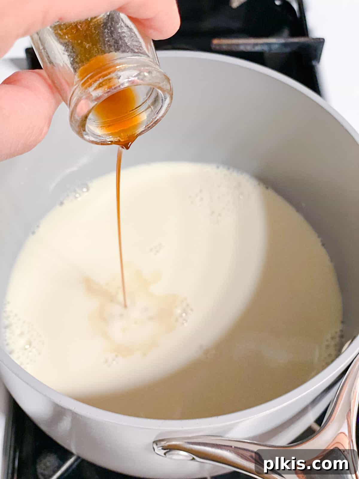 Golden Turmeric Elixir 6 Process shot of vanilla extract being added to the saucepan, enhancing the aroma and flavor of the golden milk.
