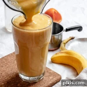 Completed Mango Orange Smoothie being poured into a cup