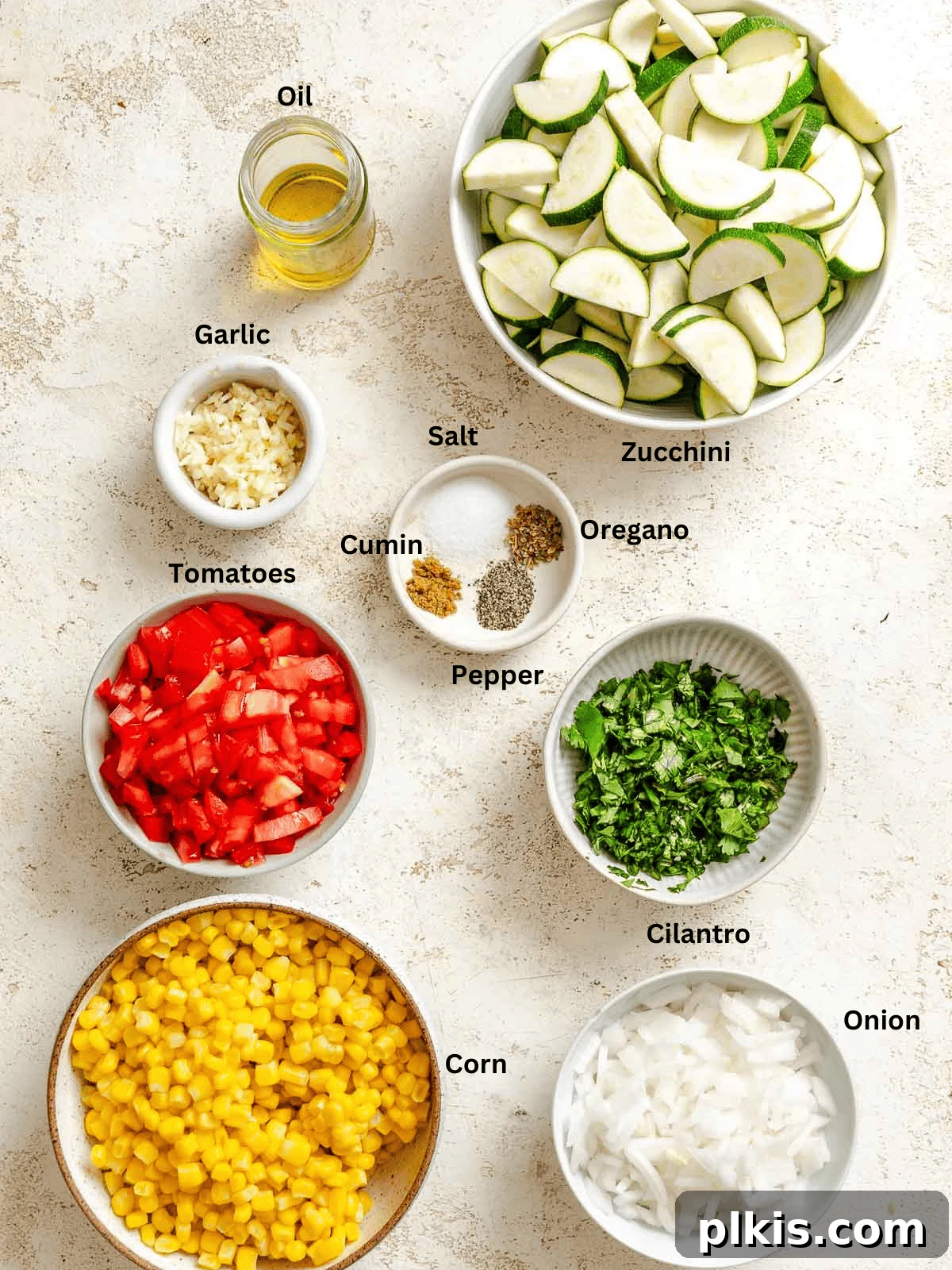 Effortless Calabacitas: A Mexican Zucchini Delight 3 Ingredients for Easy Calabacitas Recipe (Mexican Zucchini) measured out on a white surface.