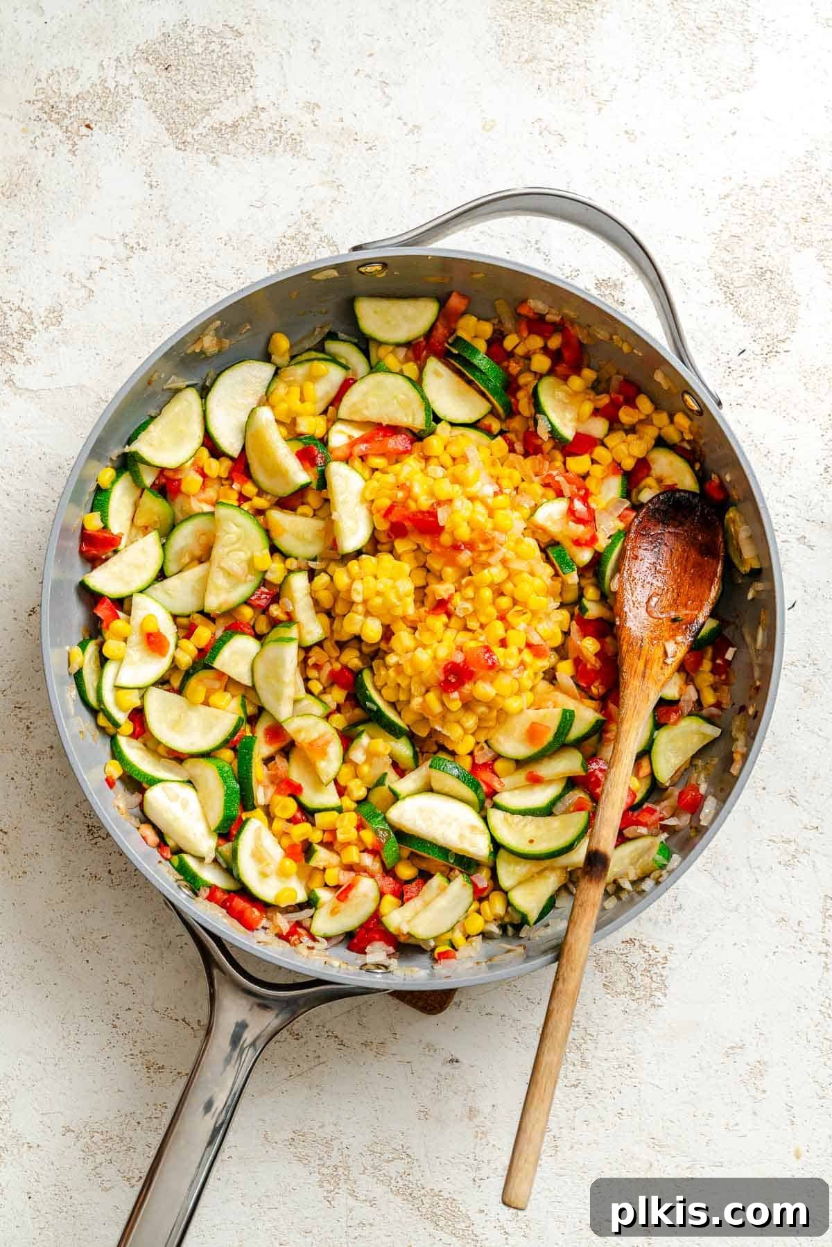 Effortless Calabacitas: A Mexican Zucchini Delight 5 Process shot showing veggies cooking in pan.