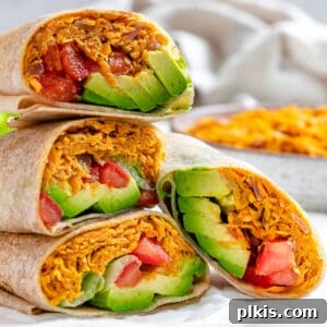 Roasted Sweet Potato and Black Bean Burritos 13 completed Sweet Potato Burritos stacked on one another against a light background