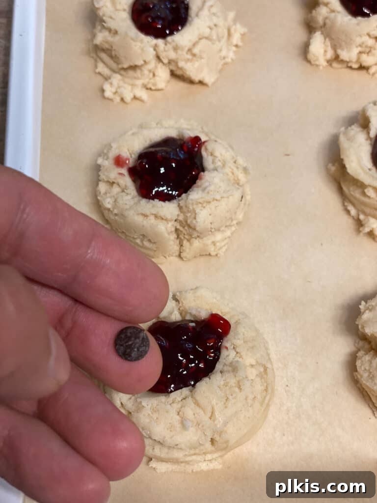 Ruby Raspberry Thumbprint Delights 16 process shot of adding chocolate chips to cookies