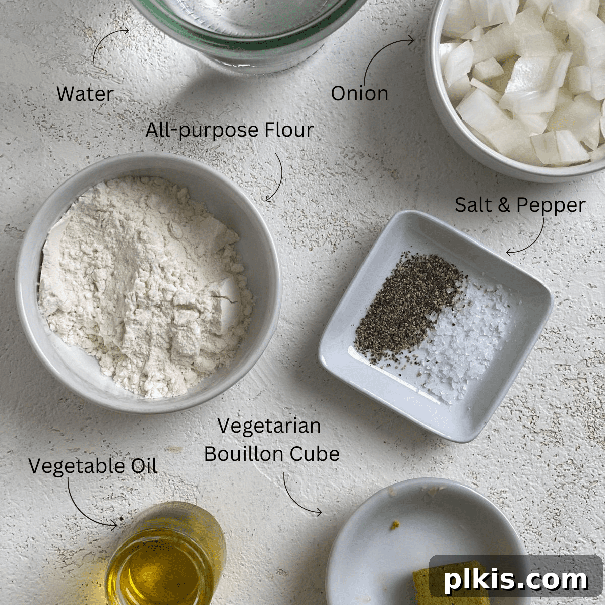 Effortless Plant-Based Gravy 3 Measured ingredients for simple vegan gravy laid out on a light surface, including onions, flour, oil, and bouillon.