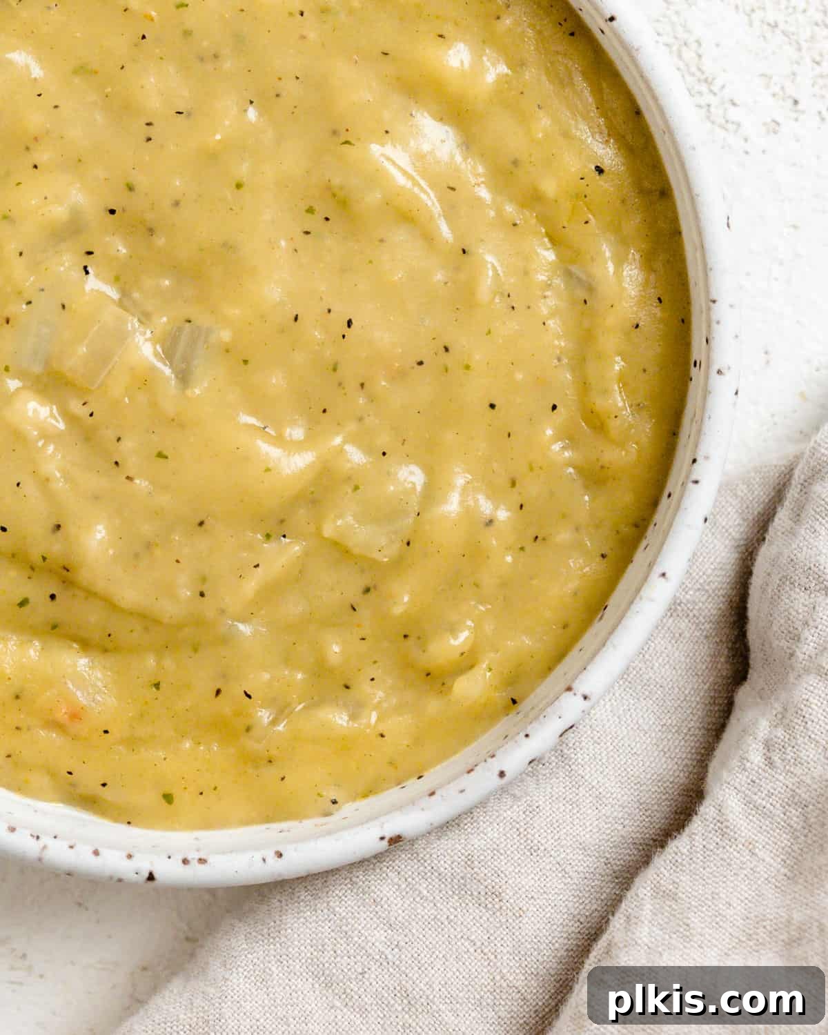Effortless Plant-Based Gravy 7 A close-up shot of the finished Easy Vegan Gravy in a rustic bowl, showcasing its smooth texture.
