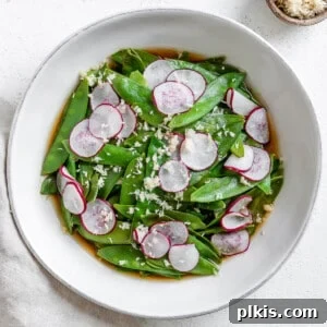 Sugar Snap Peas with Horseradish Fire 13 completed Spicy Sugar Snap Peas with Horseradish in a white bowl against a white surface