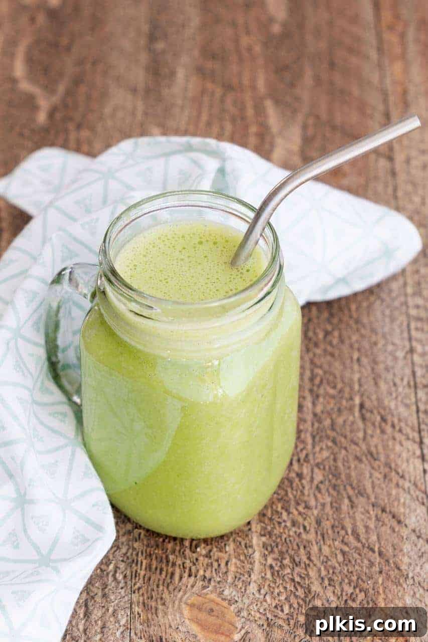 Solo Plant-Based Budget Challenge: Week 1 10 Mason jar with a handle filled with a fresh green smoothie and stainless steel straw.