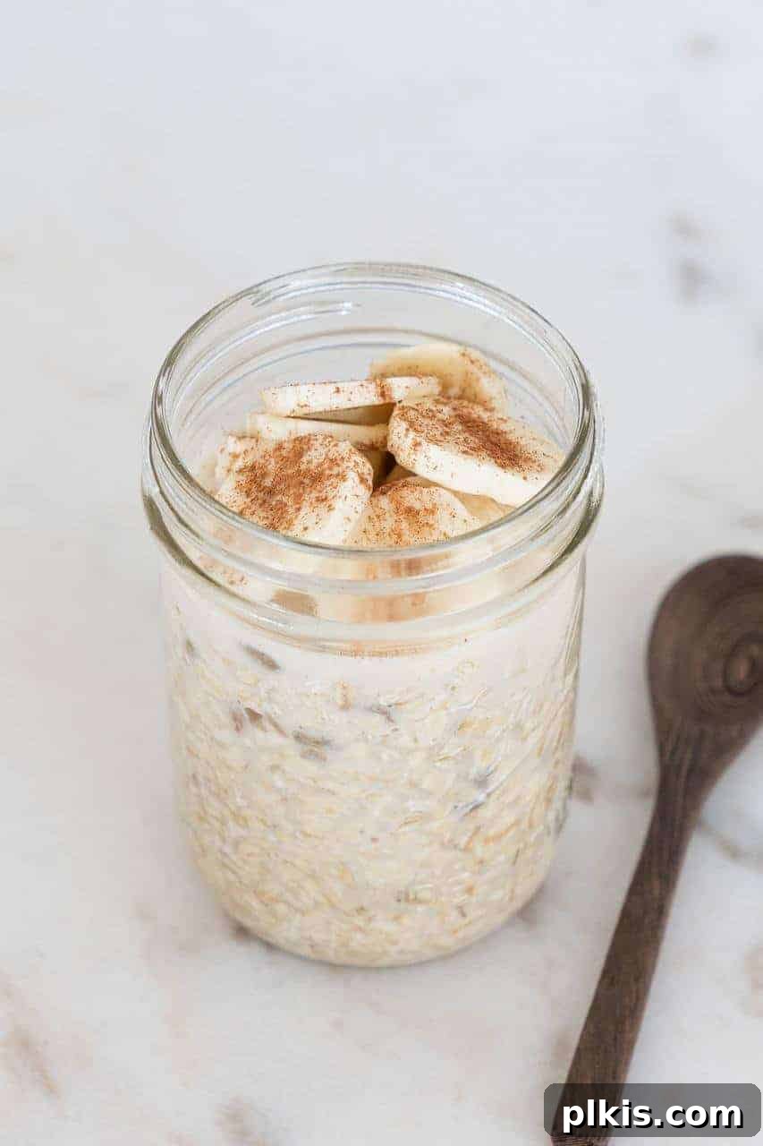 Solo Plant-Based Budget Challenge: Week 1 8 Pint Mason jar filled with overnight oats topped with sliced bananas and cinnamon.