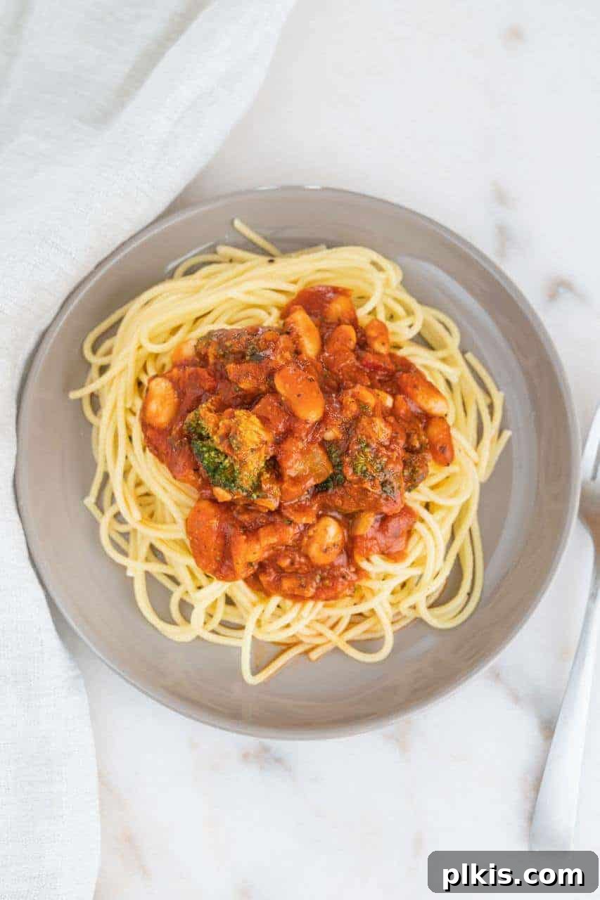 Solo Plant-Based Budget Challenge: Week 1 9 Bean and veggie pasta sauce on a plate of spaghetti.