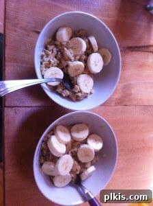 Budget Plant-Based Challenge for Two Week 2 3 Two bowls of warm, creamy oatmeal topped with fresh banana slices, ready for a nutritious plant-based breakfast.