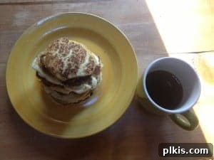 Budget Plant-Based Challenge for Two Week 2 6 A stack of golden-brown vegan pancakes, lightly dusted with powdered sugar, ready for syrup.