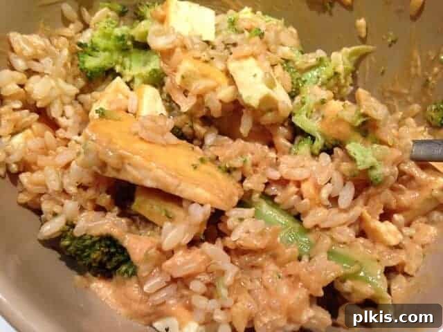 Solo Budget Plant Based Challenge Week 3 14 Tofu, spinach, and rice tossed in a homemade peanut sauce.
