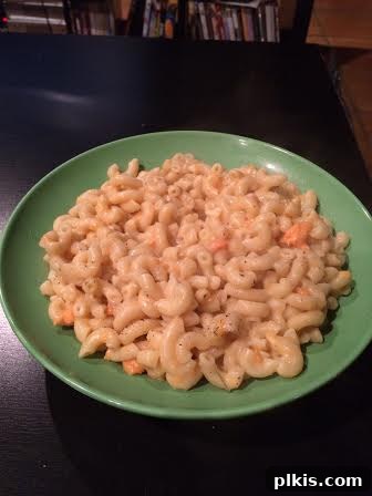 Budget Plant Based for Two Week 4 3 A vibrant bowl of vegan sweet potato macaroni and cheese, ready to be enjoyed.