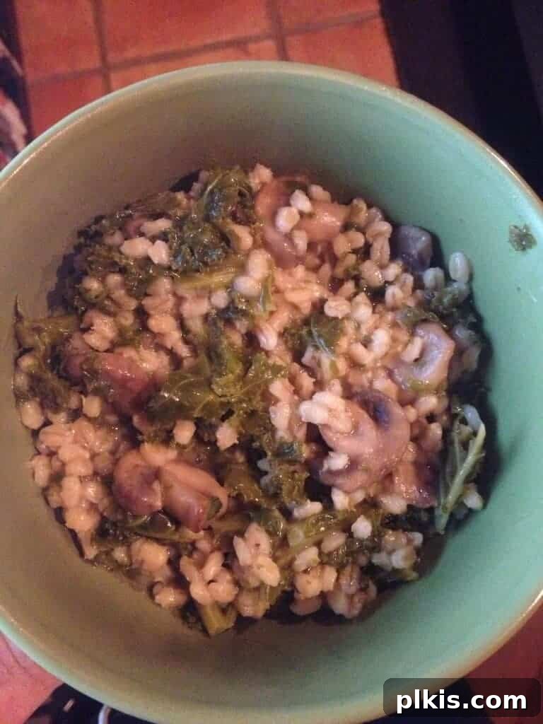 Budget Plant Based for Two Week 4 4 A cozy dinner bowl filled with mushroom barley kale pilaf, perfect for cold evenings.