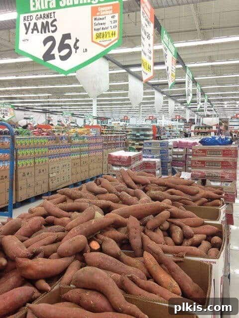 My Solo Budget Vegan Journey: Week 4 10 Crates of yams in a grocery store produce aisle.