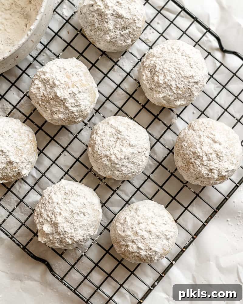 Completed Easy Snowball Cookies [Various Flavors] on cooling rack.