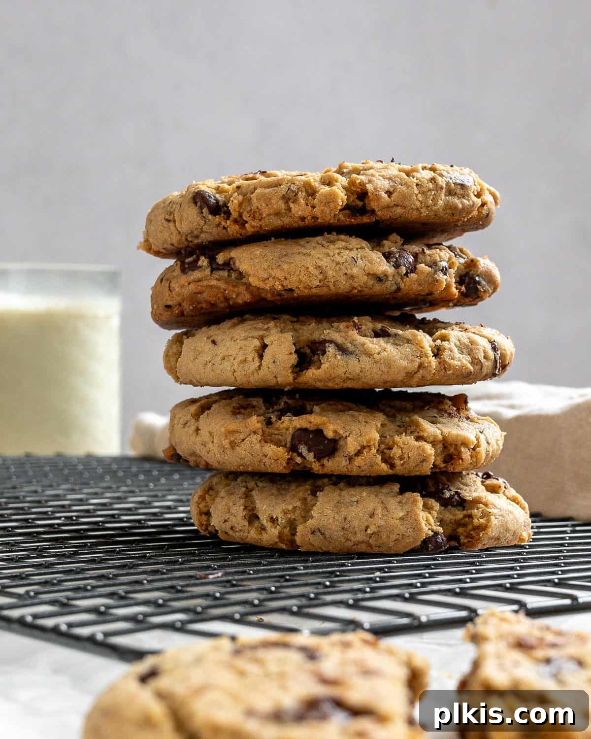 24 Festive Vegan Christmas Cookie Delights 17 Completed Dairy-free Chocolate Chip Cookies stacked on wire rack.