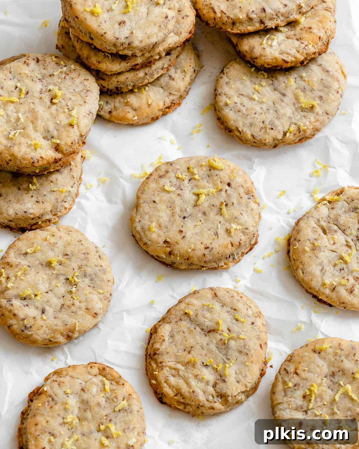 24 Festive Vegan Christmas Cookie Delights 18 Completed Vegan Lemon Shortbread Cookies scattered on a white surface.