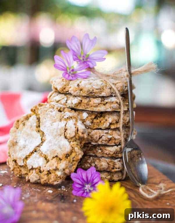 24 Festive Vegan Christmas Cookie Delights 5 A stack of vegan oatmeal crinkle cookies on a wood table.