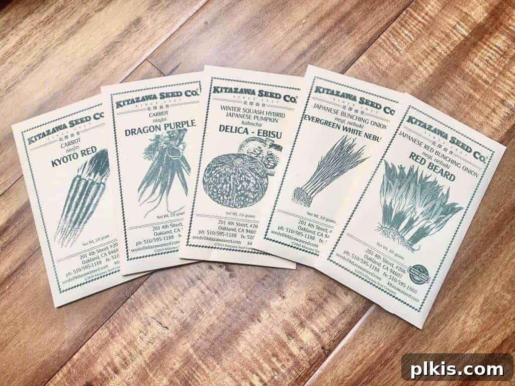 5 Best Places to Buy Seeds Online A selection of Kitazawa Seed Co. seed packets neatly arranged on a rustic wooden table.