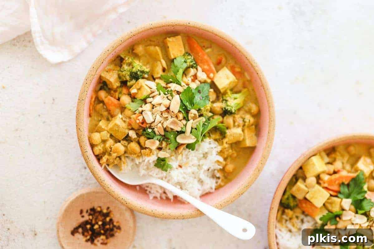 Peanut Curry Peanut Curry in a pink bowl with a white spoon inside